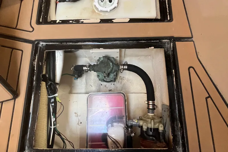 Slide: The Image of 2001 Cruisers Yachts 3470 Express engine compartment with visible hoses and wiring. - 18