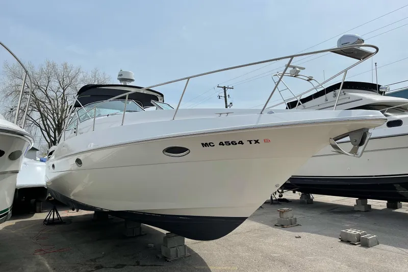 Slide: The Image of 2001 Cruisers Yachts 3470 Express boat on dry dock, side view. - 2