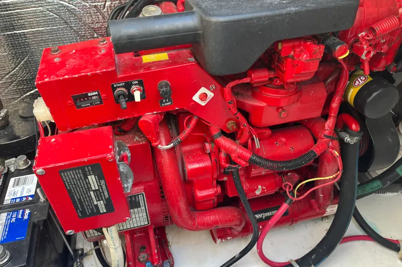 Slide: The Image of Engine compartment of a 2001 Cruisers Yachts 3470 Express, featuring a red generator. - 22