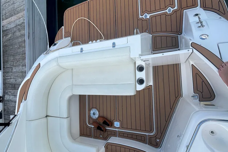 Slide: The Image of 2001 Cruisers Yachts 3470 Express boat deck with white seating and wood-style flooring. - 6