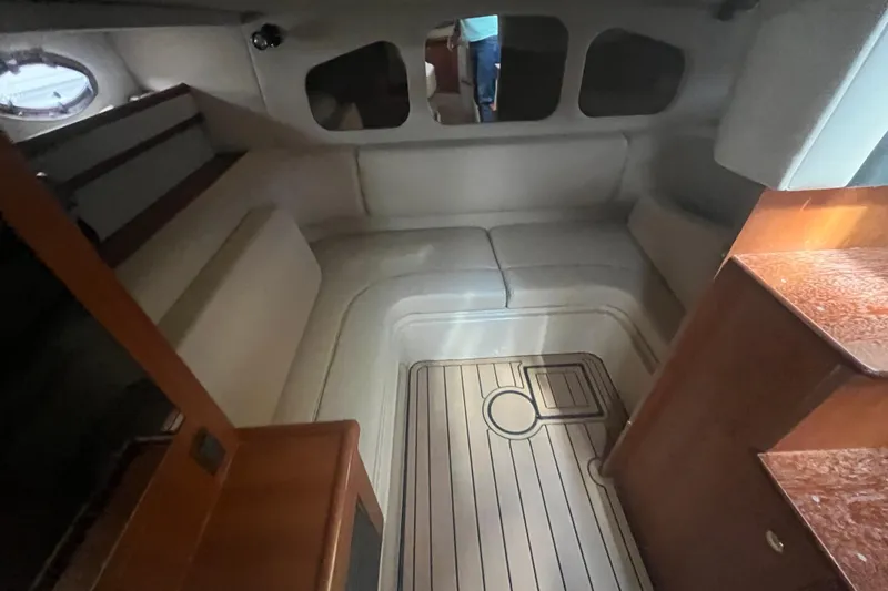 Slide: The Image of Interior of 2001 Cruisers Yachts 3470 Express, featuring seating and wood flooring. - 9