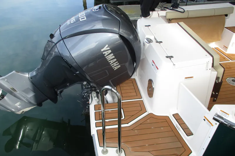 Slide: The Image of 2022 Ranger Tugs R-27 with Yamaha outboard motor, docked on wooden deck. - 17