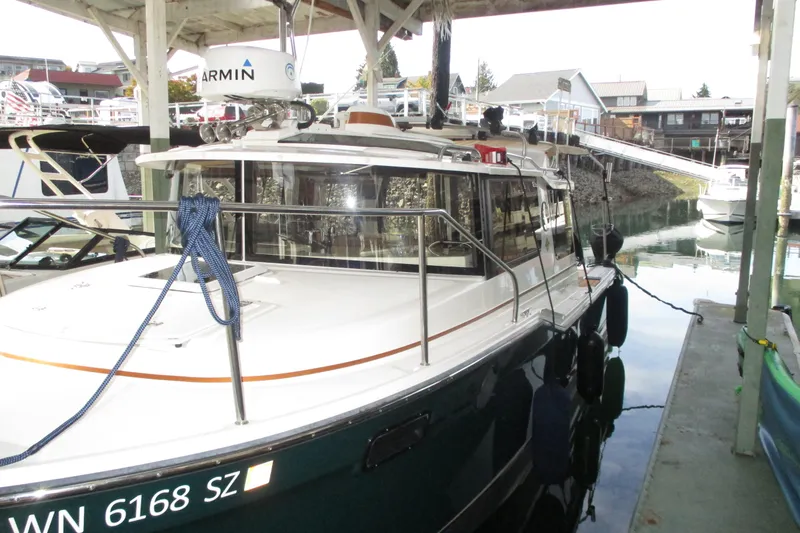 Slide: The Image of 2022 Ranger Tugs R-27 docked in a marina, featuring sleek design and modern equipment. - 26