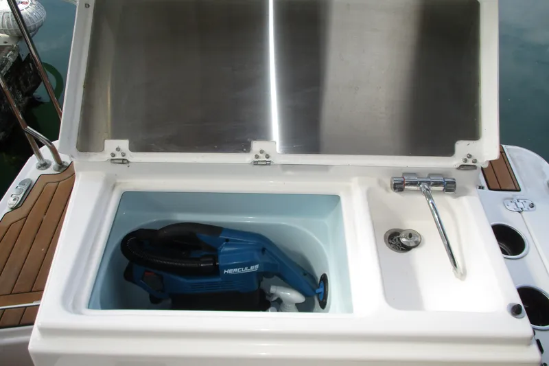 Slide: The Image of Ranger Tugs R-27 2022 boat sink with storage compartment and faucet. - 37