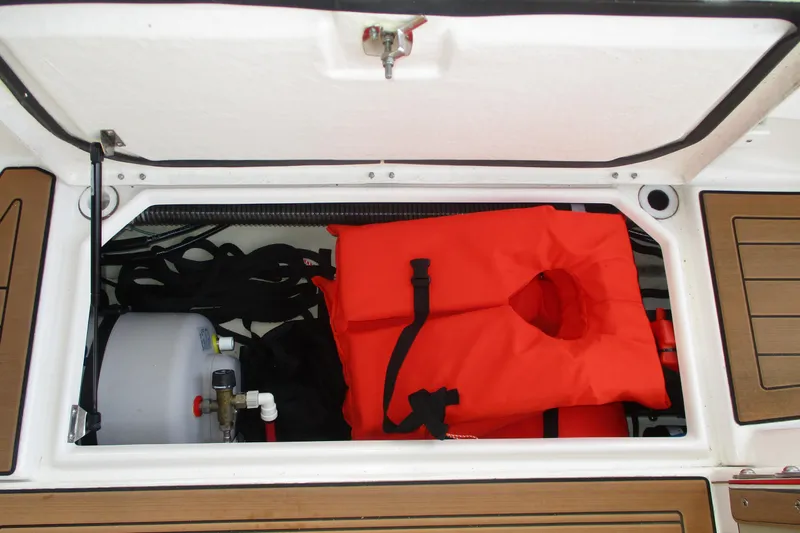 Slide: The Image of Storage compartment of 2022 Ranger Tugs R-27 with life jacket and equipment. - 38