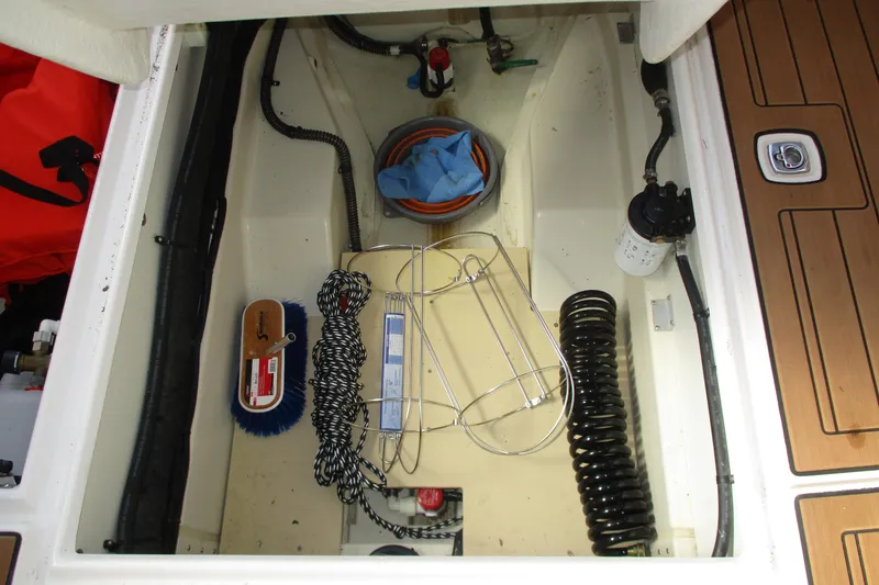 Slide: The Image of Storage compartment of a 2022 Ranger Tugs R-27 boat with cleaning supplies and equipment. - 40
