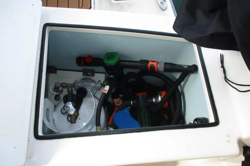Slide: The Image of Storage compartment on 2022 Ranger Tugs R-27 boat with hoses and equipment. - 41