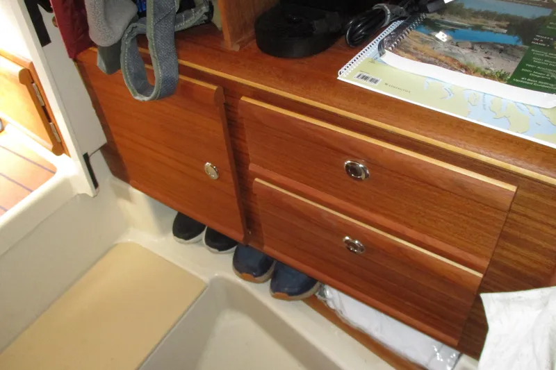 Slide: The Image of Interior of 2022 Ranger Tugs R-27 with wooden cabinetry and storage space. - 54