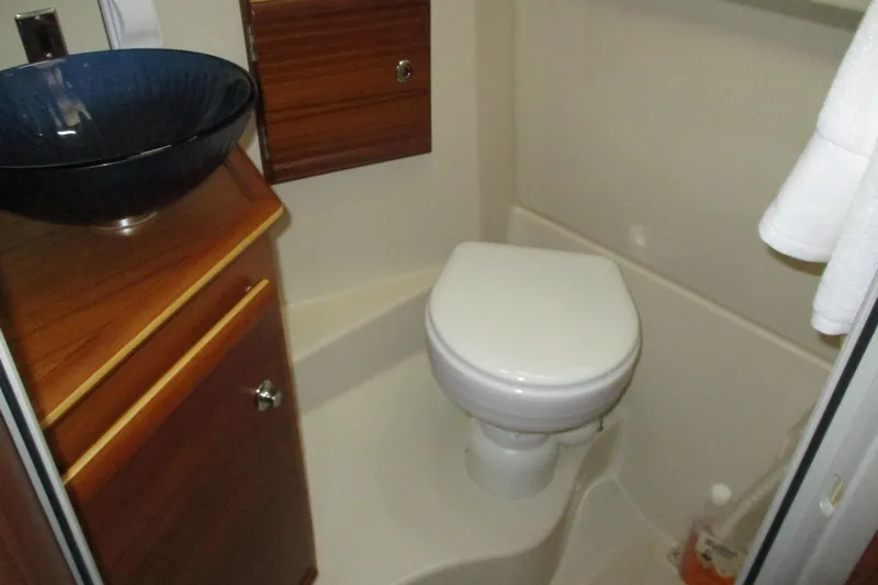 Slide: The Image of 2022 Ranger Tugs R-27 bathroom with modern sink and compact toilet. - 56