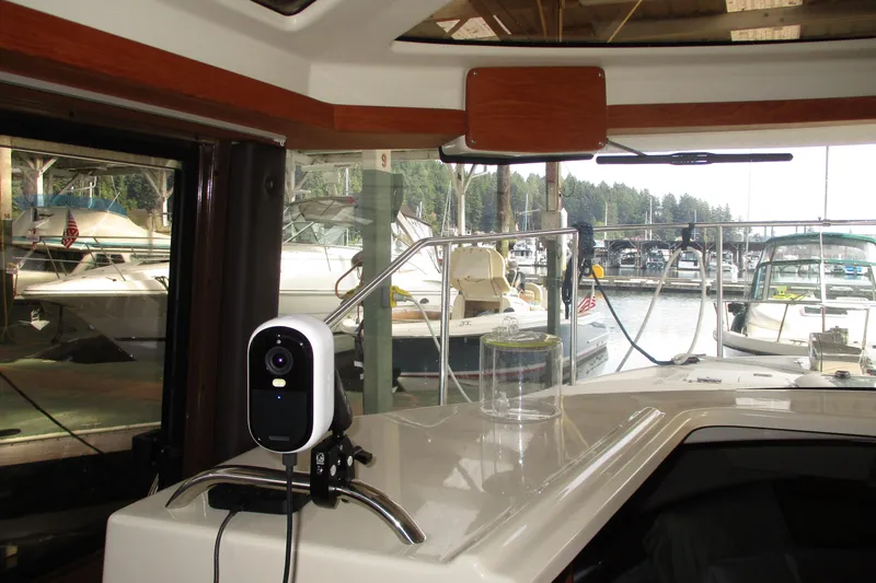 Slide: The Image of Interior view of 2022 Ranger Tugs R-27 boat with marina background. - 58