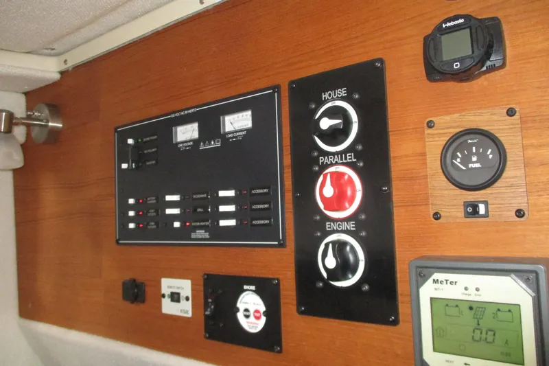 Slide: The Image of Control panel of a 2022 Ranger Tugs R-27 boat with switches and gauges. - 62