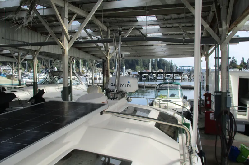 Slide: The Image of 2022 Ranger Tugs R-27 docked in a marina with solar panels and Garmin equipment. - 66
