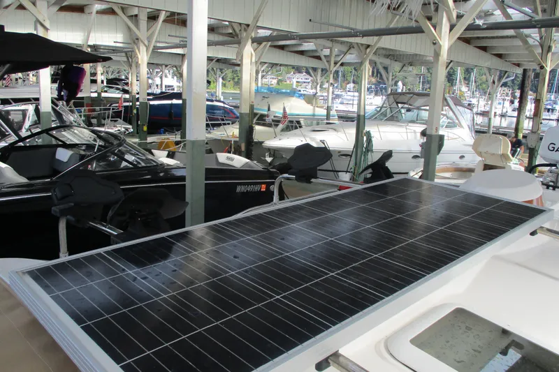 Slide: The Image of 2022 Ranger Tugs R-27 with solar panel in a marina setting. - 67