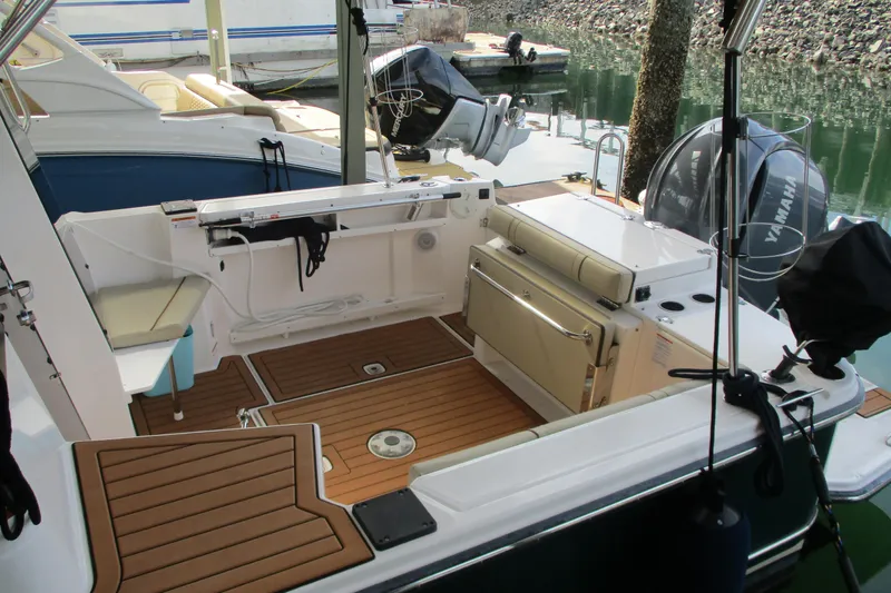 Slide: The Image of 2022 Ranger Tugs R-27 boat interior with teak flooring and Yamaha outboard motor. - 69