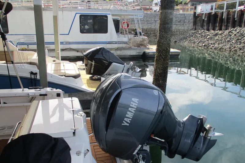 Slide: The Image of 2022 Ranger Tugs R-27 with Yamaha outboard motor docked at marina. - 70