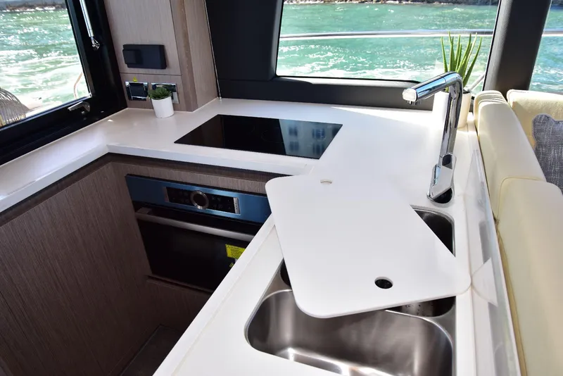 Slide: The Image of Modern kitchen in 2022 Sealine C430 yacht with sleek countertops and stainless steel sink. - 18