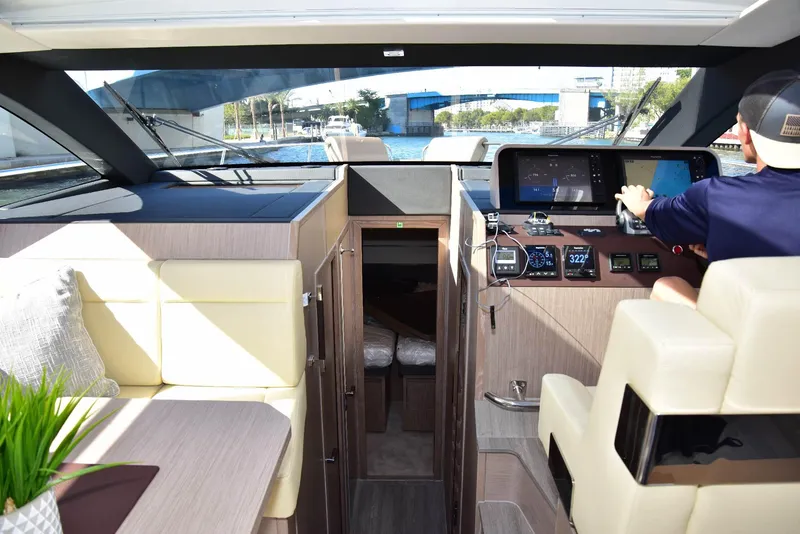 Slide: The Image of Interior view of 2022 Sealine C430 yacht cockpit with modern controls and seating. - 30