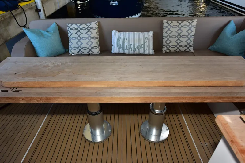 Slide: The Image of 2022 Sealine C430 yacht interior with wooden table and decorative cushions. - 41
