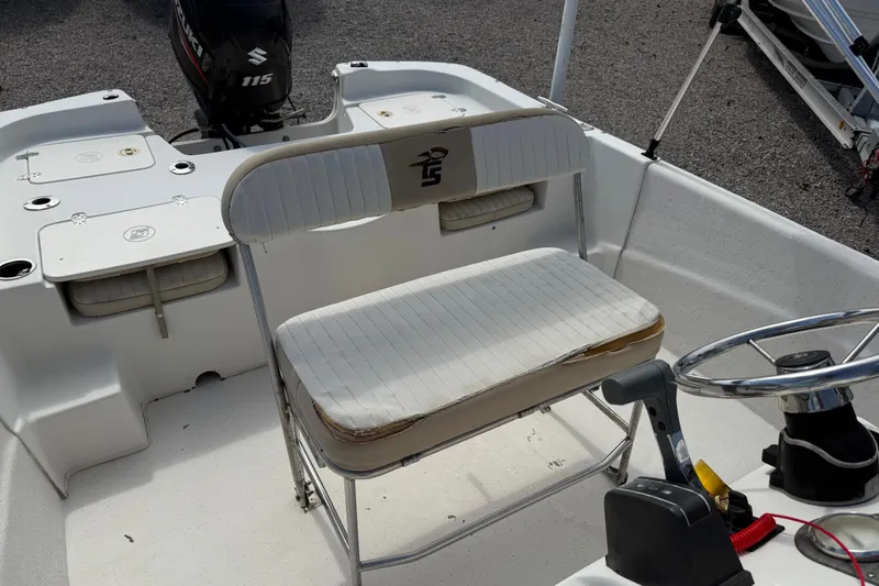 Slide: The Image of 2016 Carolina Skiff 218 DLV boat interior with seating and steering wheel. - 16