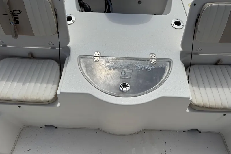 Slide: The Image of 2016 Carolina Skiff 218 DLV boat interior with seating and storage compartment. - 21