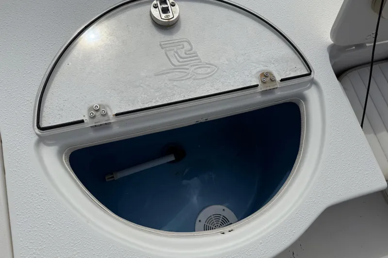 Slide: The Image of Livewell compartment on a 2016 Carolina Skiff 218 DLV boat, featuring a clear lid. - 22