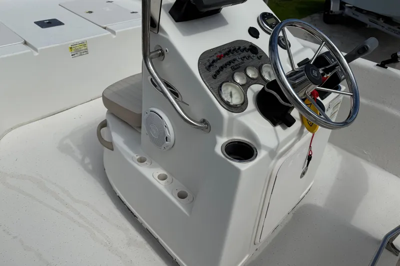 Slide: The Image of 2016 Carolina Skiff 218 DLV boat console with steering wheel and controls. - 23
