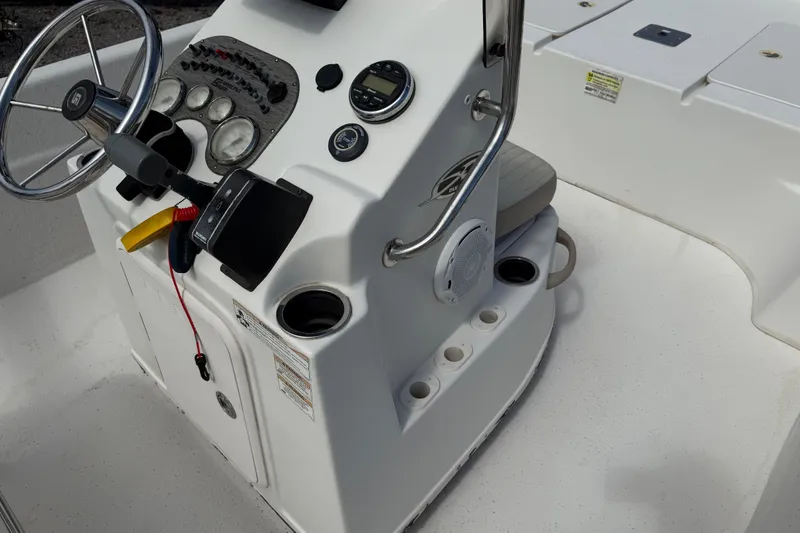 Slide: The Image of 2016 Carolina Skiff 218 DLV boat console with steering wheel and controls. - 24