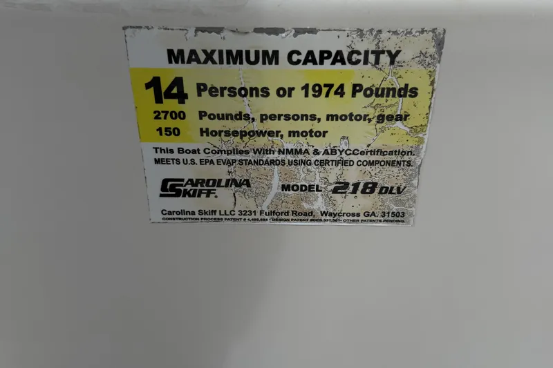 Slide: The Image of 2016 Carolina Skiff 218 DLV capacity label, 14 persons or 1974 pounds, 150 horsepower. - 25