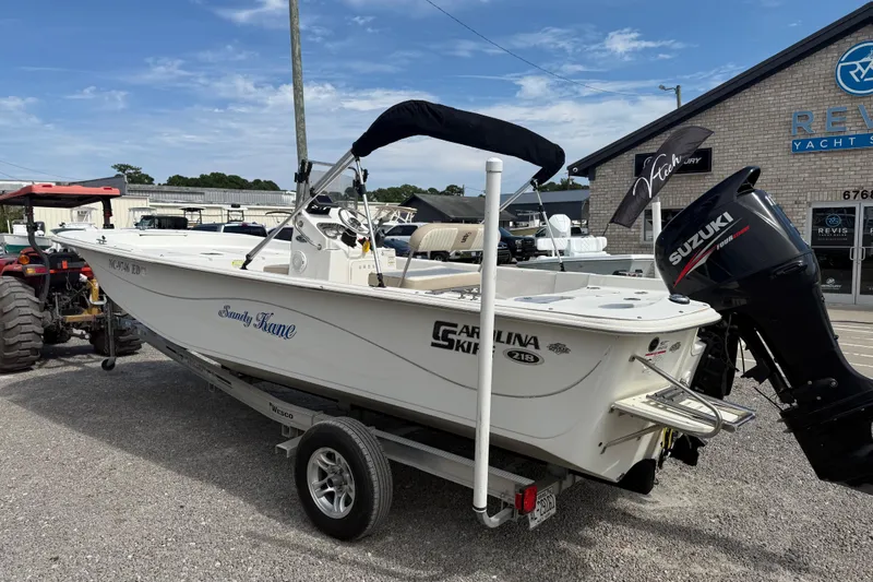 Slide: The Image of 2016 Carolina Skiff 218 DLV boat on trailer with Suzuki outboard motor. - 3