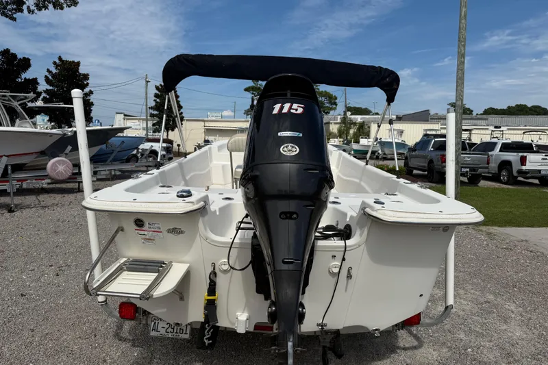 Slide: The Image of 2016 Carolina Skiff 218 DLV boat with outboard motor, parked on gravel lot. - 5