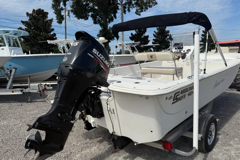Slide: The Image of 2016 Carolina Skiff 218 DLV boat with Suzuki outboard motor on trailer. - 6