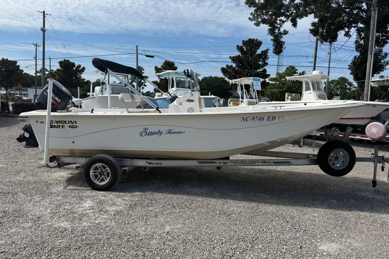 Slide: The Image of 2016 Carolina Skiff 218 DLV boat on trailer in outdoor setting. - 8