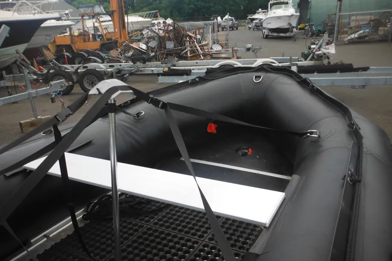 Slide: The Image of 2020 Bris BSA470 inflatable boat in a boatyard with trailers and equipment. - 4
