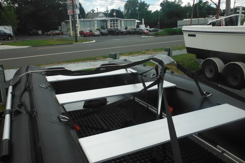 Slide: The Image of 2020 Bris BSA470 inflatable boat with aluminum seats, parked near a road. - 5