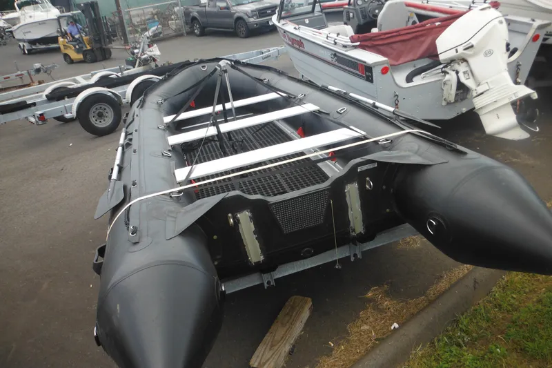 Slide: The Image of 2020 Bris BSA470 inflatable boat on trailer in a parking lot. - 7