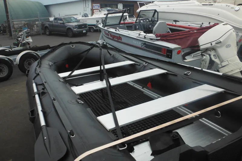 Slide: The Image of 2020 Bris BSA470 inflatable boat with oars, parked in a marina. - 8