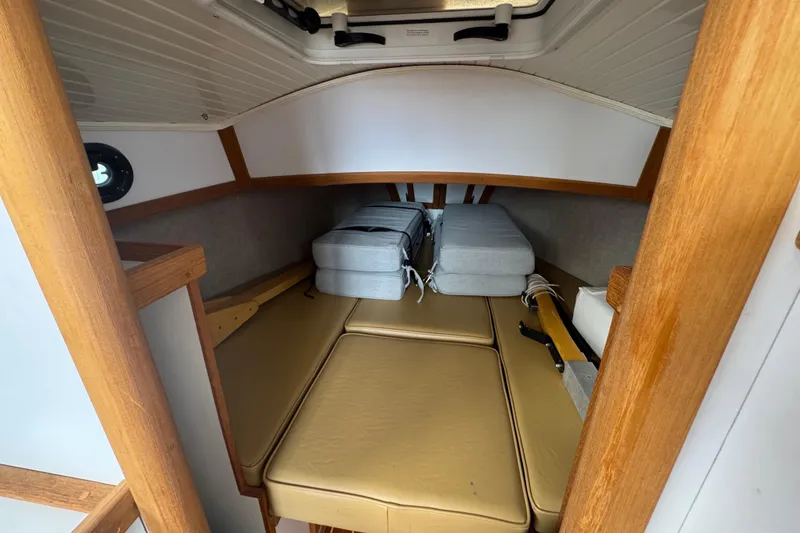 Slide: The Image of 2022 Com-Pac CP 23 Pilothouse interior with cozy cabin and wooden accents. - 10