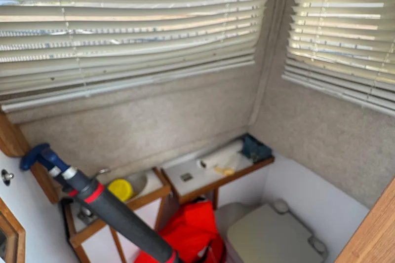 Slide: The Image of Interior of 2022 Com-Pac CP 23 Pilothouse with compact bathroom and storage area. - 14