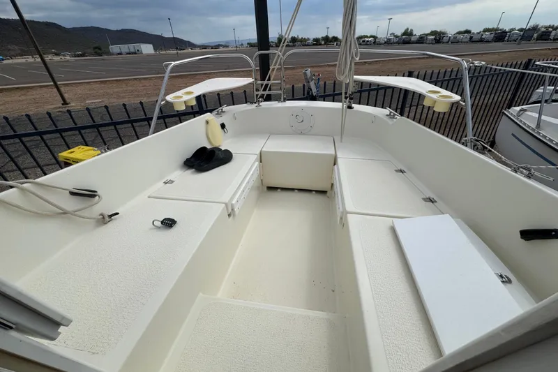 Slide: The Image of 2022 Com-Pac CP 23 Pilothouse boat interior with seating and storage compartments. - 19