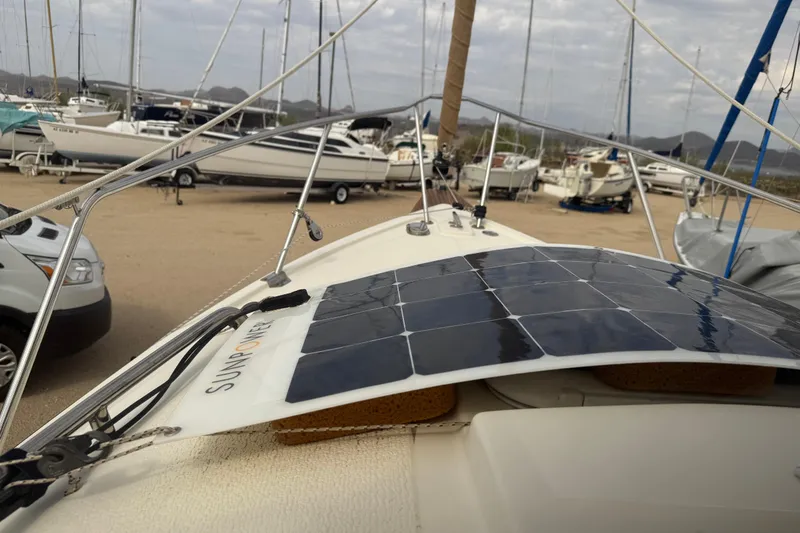 Slide: The Image of 2022 Com-Pac CP 23 Pilothouse with solar panel, docked among other boats. - 20