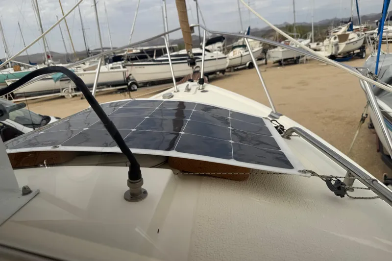 Slide: The Image of 2022 Com-Pac CP 23 Pilothouse with solar panel on deck, docked at marina. - 21