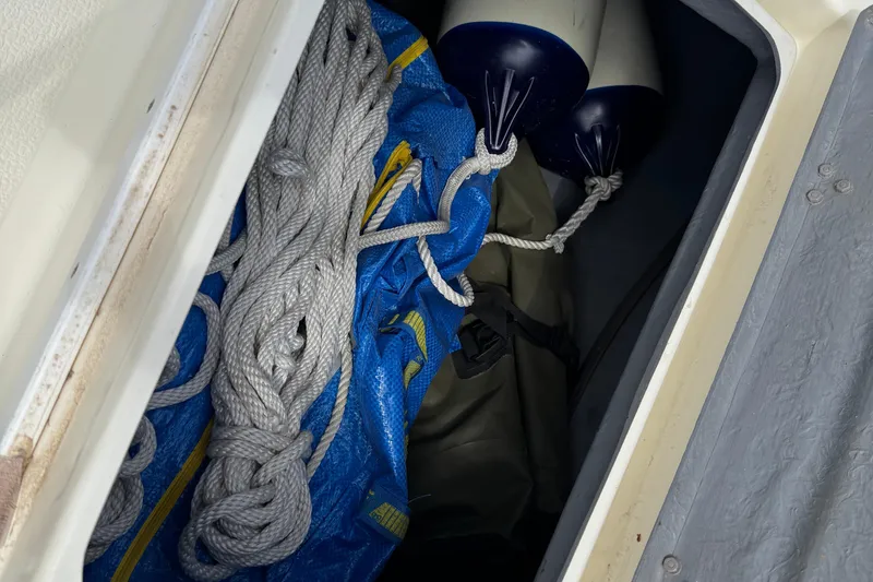 Slide: The Image of Storage compartment of 2022 Com-Pac CP 23 Pilothouse with ropes and fenders. - 34