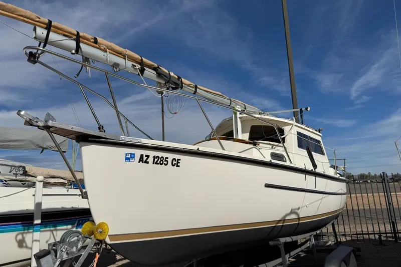 Slide: The Image of 2022 Com-Pac CP 23 Pilothouse sailboat on trailer under clear blue sky. - 36