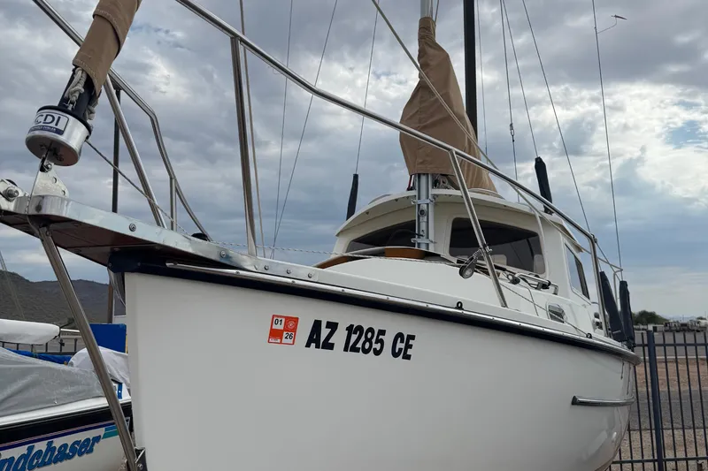 Slide: The Image of 2022 Com-Pac CP 23 Pilothouse sailboat docked, showcasing sleek design and registration number. - 5