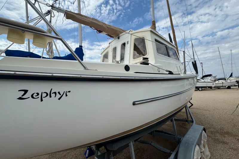 Slide: The Image of 2022 Com-Pac CP 23 Pilothouse sailboat named Zephyr on a trailer, under a cloudy sky. - 7