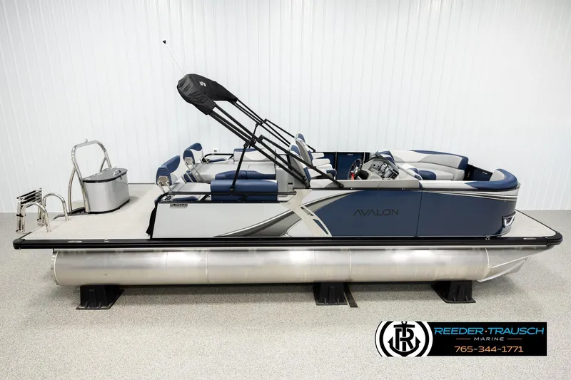 The Image of 2026 Avalon LSZ QLS pontoon boat in showroom, side view, blue and silver design. - 1