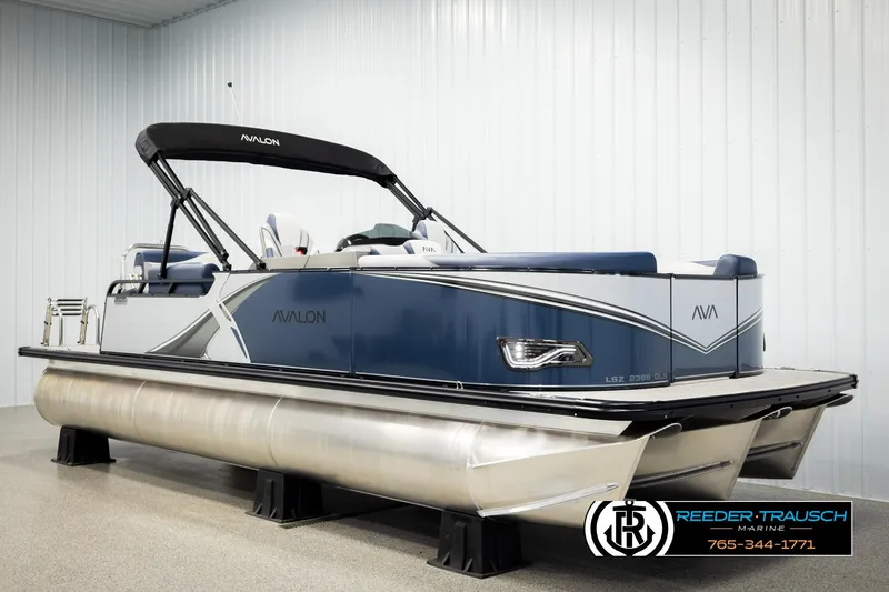 Slide: The Image of 2026 Avalon LSZ QLS pontoon boat in showroom, featuring sleek design and modern amenities. - 2