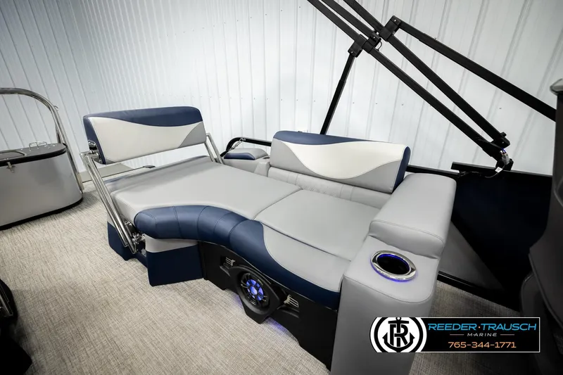 Slide: The Image of 2026 Avalon LSZ QLS boat interior with luxurious seating and cup holder, showcased by Reeder-Trausch Marine. - 23