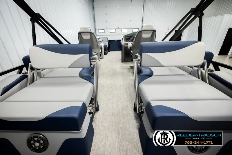 Slide: The Image of 2026 Avalon LSZ QLS boat interior with blue and white seating, showcased by Reeder-Trausch Marine. - 26