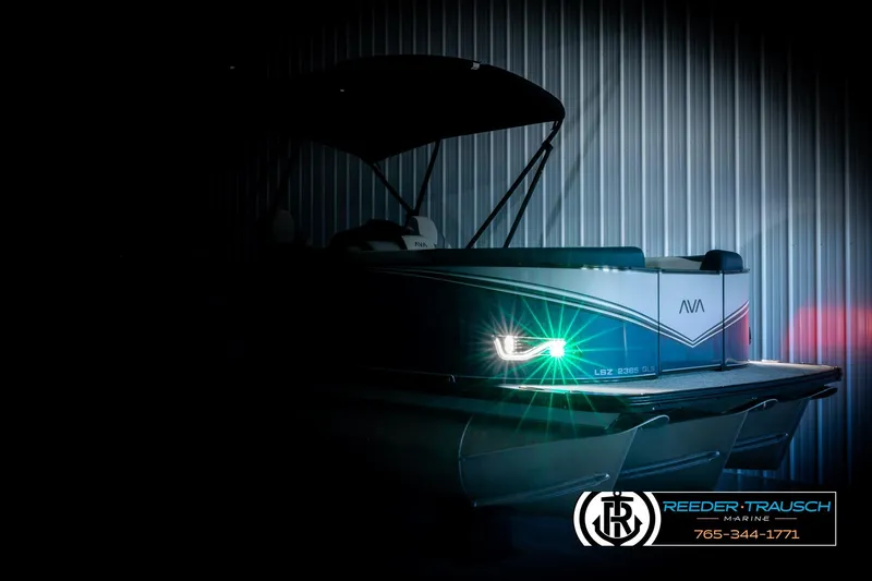 Slide: The Image of 2026 Avalon LSZ QLS pontoon boat with illuminated LED lights in a dimly lit setting. - 4